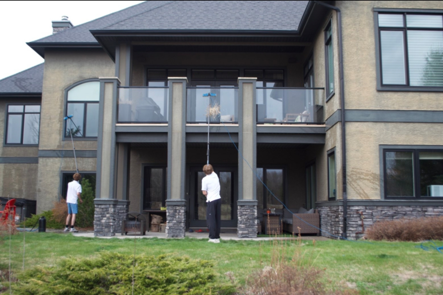 Professional window washer cleaning a Calgary home